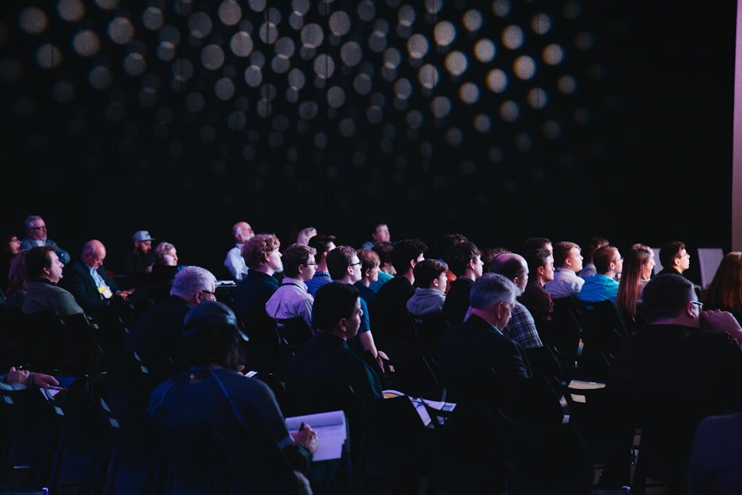 Fintech conference event with large screen and audience